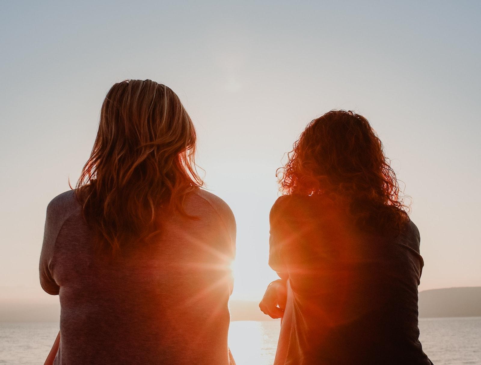 silhouette of two women watching sunrise